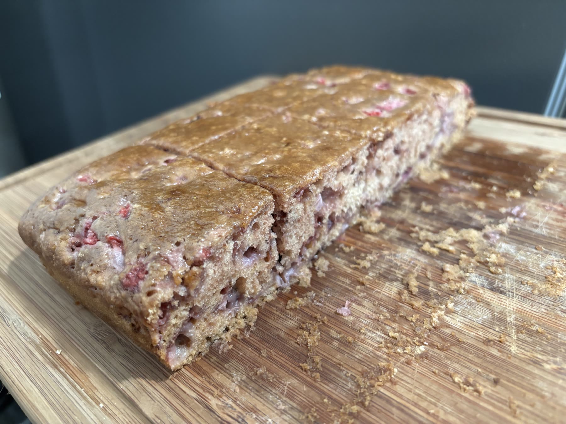 Finished strawberry bread loaf on a cutting board