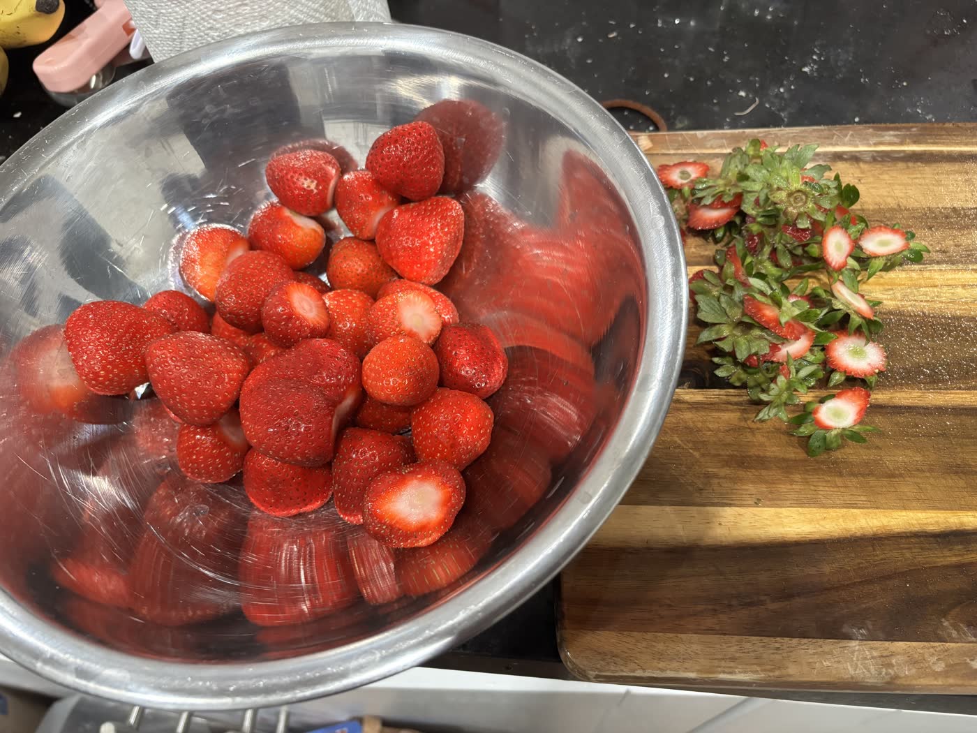 Trimmed strawberries in a mixing bowl